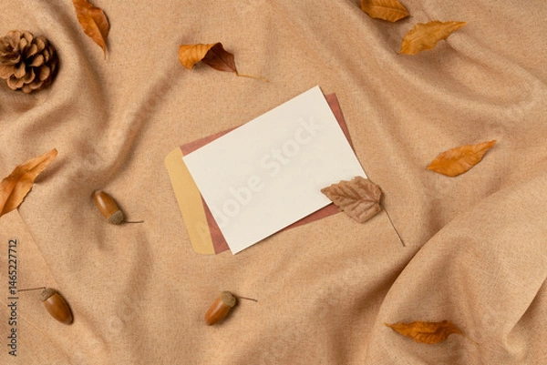 Obraz Empty white paper list on fabric background from above. Flat lay, top view.
