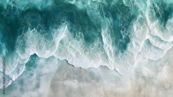Obraz High-angle view of turquoise waves crashing on light beige sand.