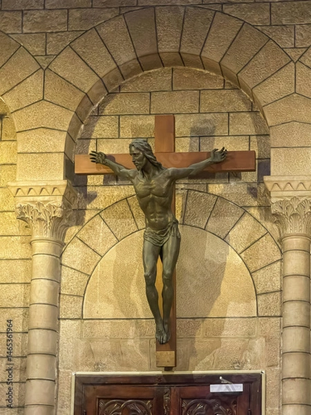 Fototapeta Principality of Monaco, France - July 9, 2024: Cathedral of Our Immaculate Lady. Jesus on the cross seems strong and ready to jump.
