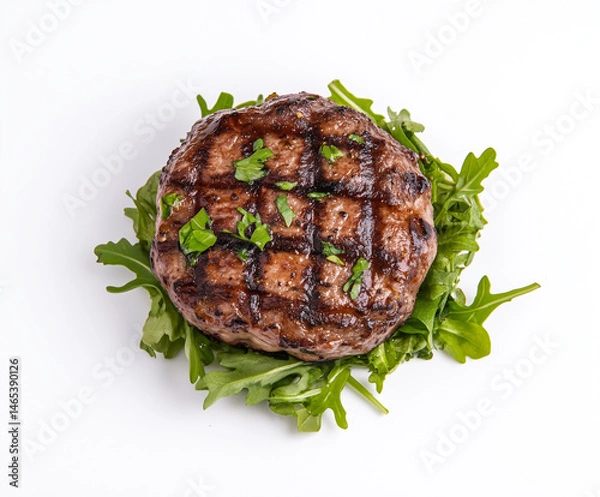 Fototapeta A perfectly grilled burger patty, with savory grill marks and a juicy interior, is artfully arranged on a bed of fresh arugula.