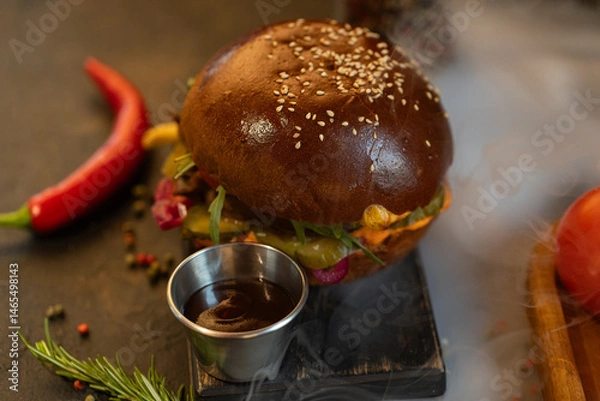Fototapeta Closeup of hamburger and fries served at restaurant
