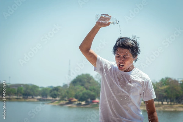 Obraz Young man pouring water