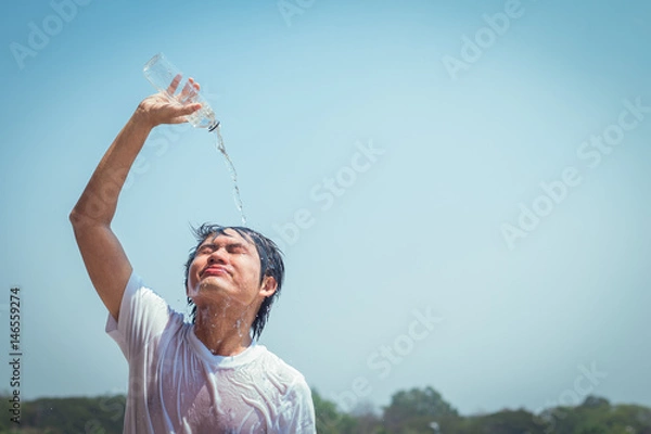 Obraz Young man pouring water