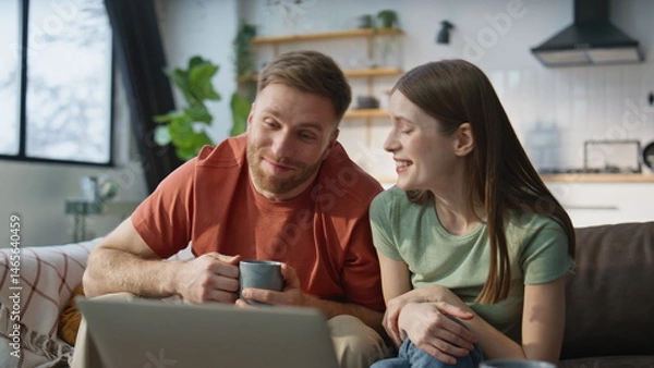 Fototapeta Spouses enjoy online meeting with family using laptop internet at home closeup