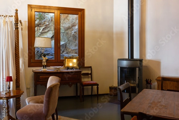 Obraz Open-space interior finely decorated with classical-style furniture, with a desk and a wood stove
