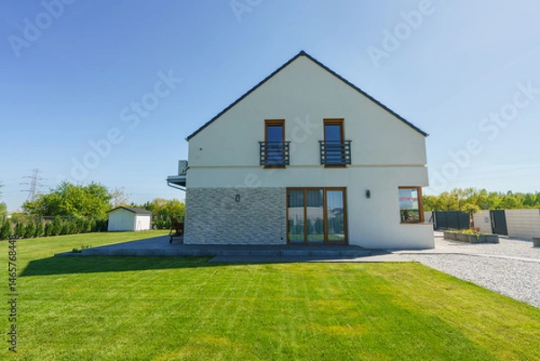 Fototapeta Side view of new build house with freshly cut grass
