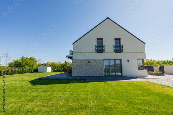 Fototapeta Side view of new build house with freshly cut grass