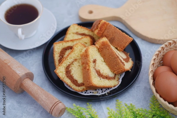 Fototapeta Delicious cake slices with a cup of tea on a table