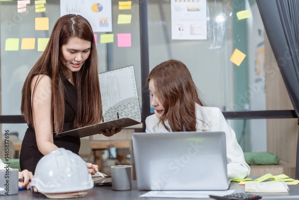 Obraz Female Creative Team Collaborating on Project in Modern Office Space.