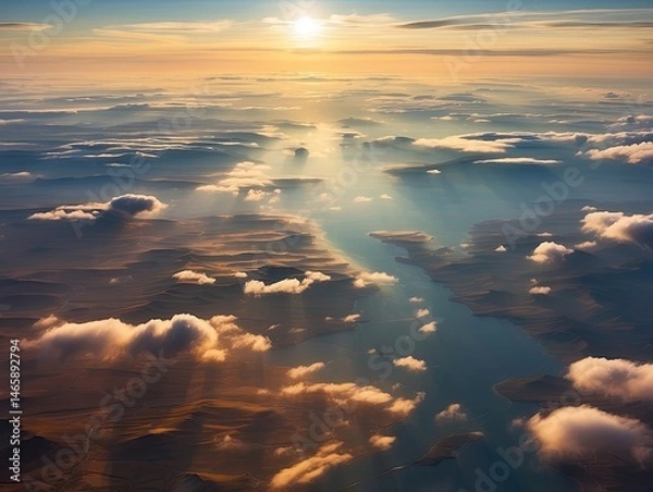 Fototapeta Sunrise view from an airplane window, featuring white clouds and a vibrant blue sky.