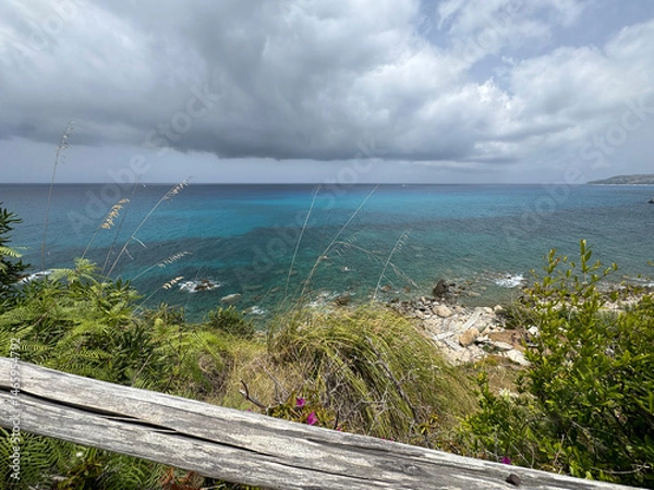 Fototapeta cloud over sea and steep green coast in calabria italy