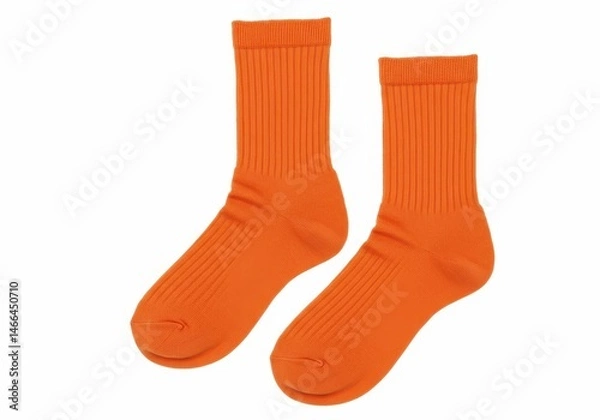 Fototapeta Two bright orange ribbed socks are displayed on a white background, showcasing their texture and vibrant color
