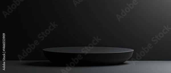 Fototapeta Black circular pedestal on dark background with soft shadow and minimalist lighting perfect for luxury product display, branding or elegant modern mockup
