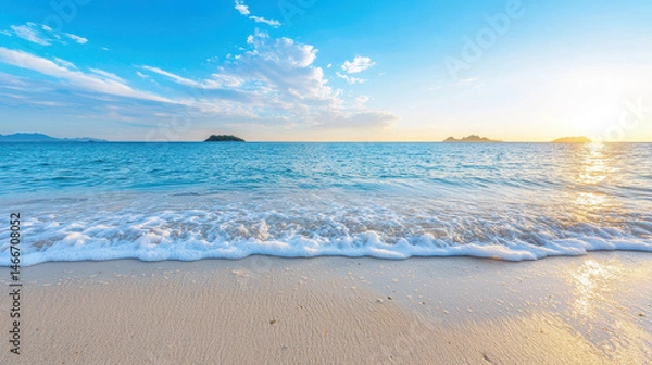Obraz Serene beach scene with gentle waves lapping at shore under bright blue sky, evoking sense of tranquility and relaxation