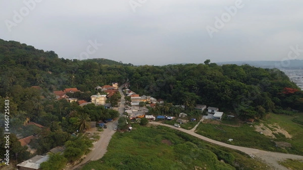 Obraz Tranquil aerial photograph captures the beauty of a charming rural village nestled amidst rolling hills and lush greenery.