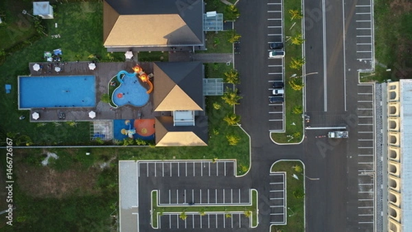Obraz Aerial View of Modern Recreation Center: High-angle shot depicts a modern recreational center with swimming pool, parking area, and buildings, illustrating a well-planned outdoor space. 