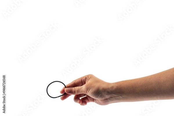 Fototapeta Black rubber band in hand isolated on transparent background