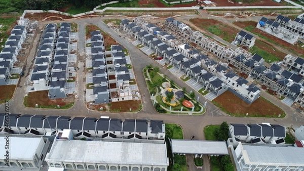 Obraz A picturesque aerial view showcases a newly developed residential area, with rows of modern houses arranged in an organized layout