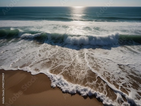 Fototapeta A mesmerizing aerial top-view photograph capturing the spectacular dance of ocean waves