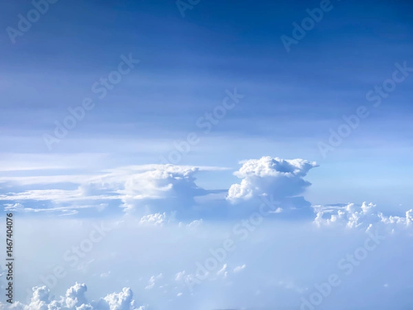 Obraz The blue sky with white clouds seen from aeroplane during sunny day. Empty blank copy text space. Concept for heaven.