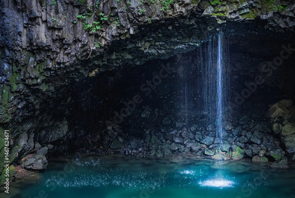 Fototapeta Waterfall in the volcanic terrain with columnar joint and river cave (corrasional cave), Hantan River, Dove's Pocket (nest) Waterfall, South Korea