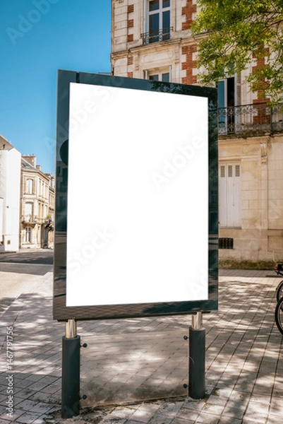 Fototapeta Blank billboard on tiled sidewalk near historic corner - mockup