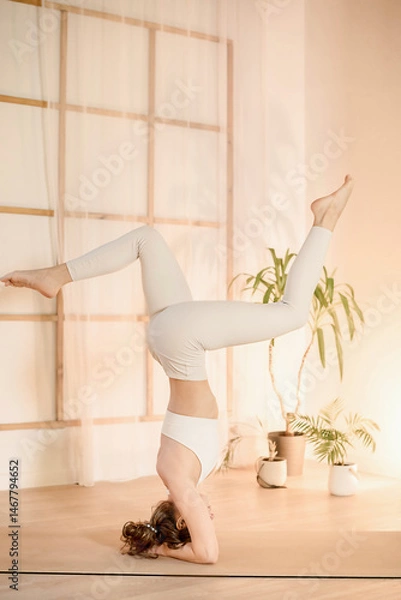 Fototapeta Handstand pose held with still focus in serene space, two woman demonstrates body control, focus flows from strength to silence, focus-driven moment ideal for wellness visuals mindful yoga practice