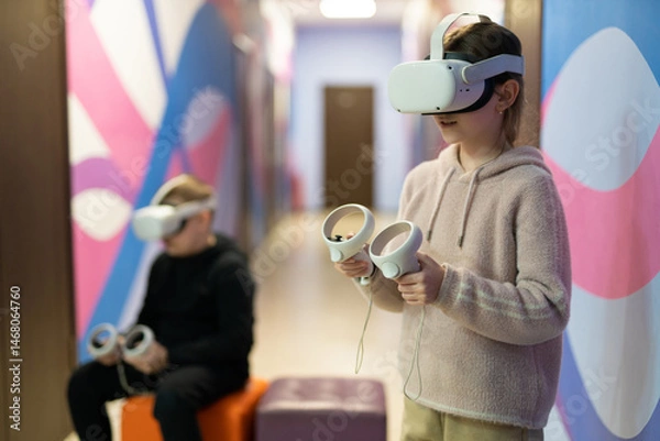 Obraz a child in virtual reality glasses plays a game