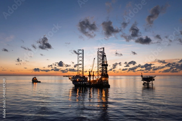 Obraz Aerial view of offshore jack up drilling rig during sunset - oil and gas industry.
