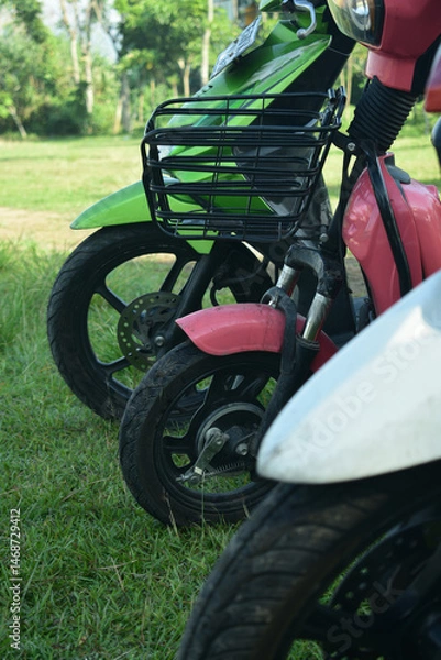 Fototapeta electric bikes are parked between motorbikes