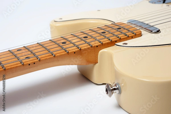 Obraz Six-string electric guitar, with a cream-colored wooden body and chrome-plated fittings.
