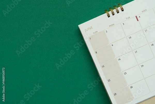 Fototapeta close up of calendar on the green table background, planning for business meeting or travel planning concept
