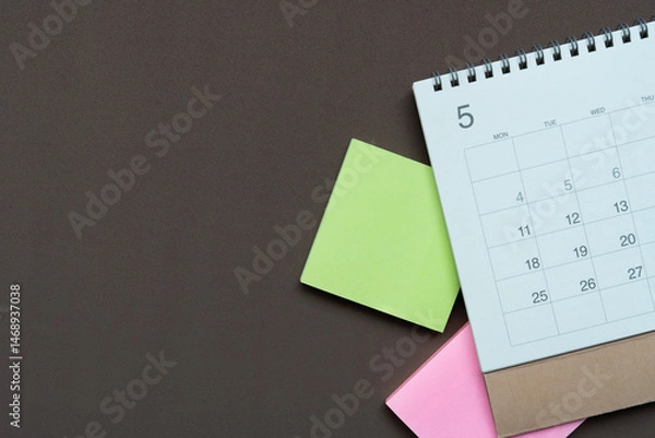 Fototapeta close up of calendar on the brown table background, planning for business meeting or travel planning concept