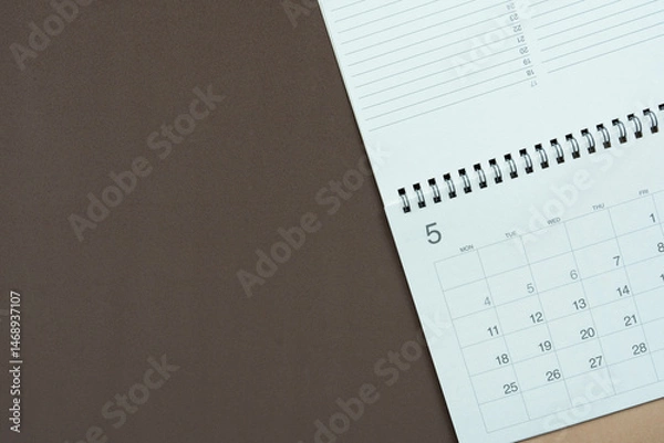 Fototapeta close up of calendar on the brown table background, planning for business meeting or travel planning concept