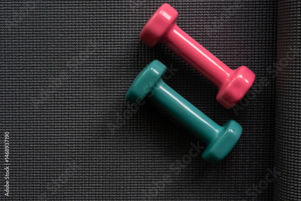 Fototapeta close up dumbbell on a yoga mat background, sport and healthy concept