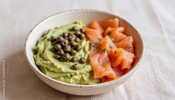 Fototapeta Delicious bowl of salmon and avocado spread with capers.