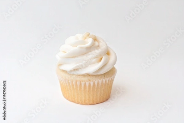 Fototapeta Vanilla cupcake with swirled white frosting on top
