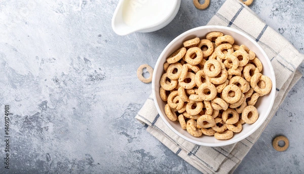 Fototapeta Generated image Whole grain cereal rings in bowl on concrete background. Healthy breakfast. Top view.