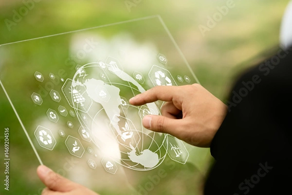 Fototapeta Businessman typing on computer doing field analysis with virtual icons about environment, analysis, investment, green business etc.