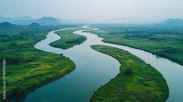 Obraz Serpentine River Flowing Through Verdant Landscape in a Natural Vista