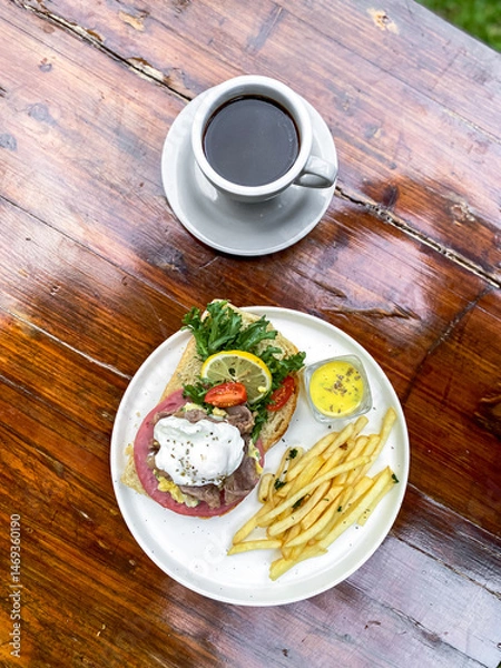 Fototapeta Vertical full plate of Open Sandwich with egg, fries, and smoked beef, ready for online sales.