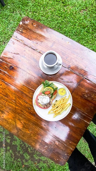 Fototapeta Outdoor view of Open Sandwich with egg, fries, and smoked beef in a bright setting for online sales.