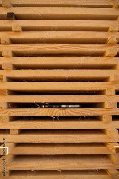 Fototapeta Front view of organized stack of wooden boards drying at lumberyard