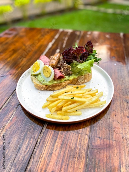 Fototapeta Bright setting for outdoor display of open sandwich with ingredients ready for market.