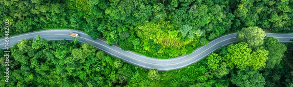 Obraz Electric cars to protect the environment and transportation road of Aerial view of a road in the middle of the forest , road curve construction up to mountain