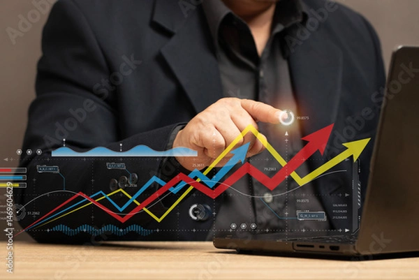 Fototapeta businessman uses technology to analyze business and financial data. graphs showing market trends, economic growth and investment decisions and filled with elements help make data analysis accurate.