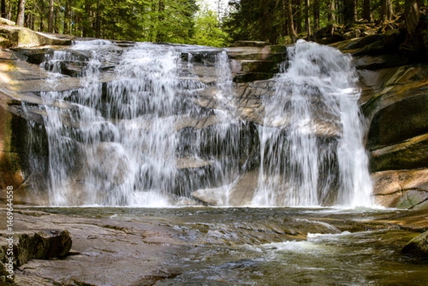 Fototapeta Mumlava Waterfall is located in the Czech Republic in the Mumlava Valley near Harrachov, a mountain resort in the Krkonoše Mountains, where the wild mountain river Mumlava flows through rocky rapids. 