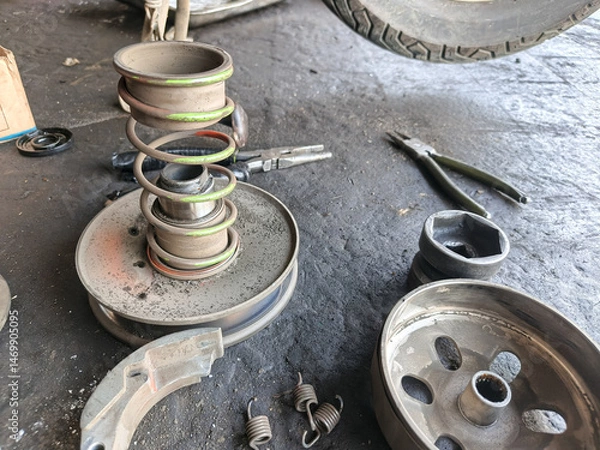 Obraz Automotive parts disassembled for repair on a shop floor.