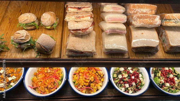 Fototapeta Variety of Sandwiches and Salads Displayed Delicious assortment ready for purchase in a cafe Bakery