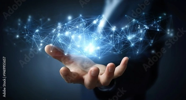 Fototapeta A businessman's hand holds a virtual, glowing network connection structure with blue light on a